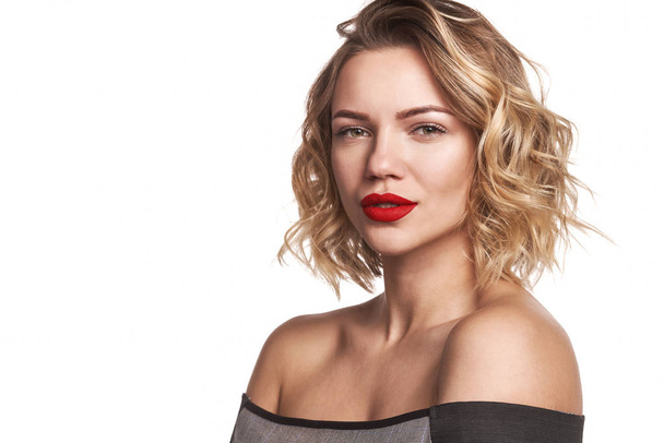 Beautiful stylish woman with red lips looking at camera - Fotó, kép
