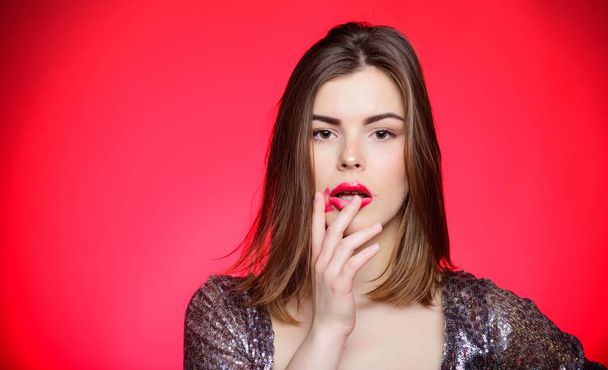 Resistant lipstick. Woman with spoiled makeup. Makeup and cosmetics concept. Beauty tips. Girl makeup lips posing over red background. Makeup for party. Resistant products for excellent make up - Фото, изображение