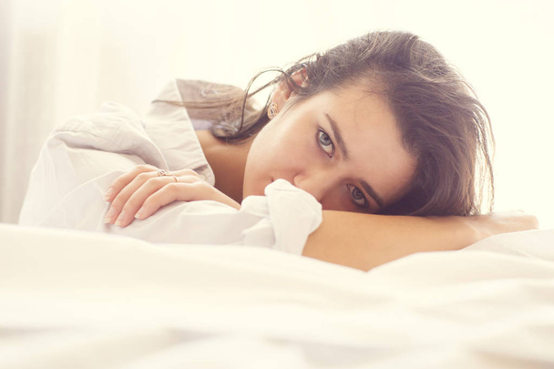 Сексуальна молода жінка позує на ліжку
 - Фото, зображення