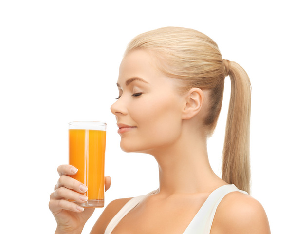 Young woman drinking orange juice - Fotó, kép
