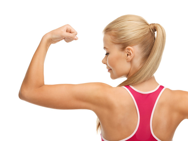 Sporty woman showing her biceps - Φωτογραφία, εικόνα