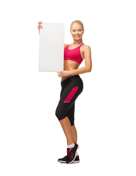 Sportswoman with white blank board - Photo, image