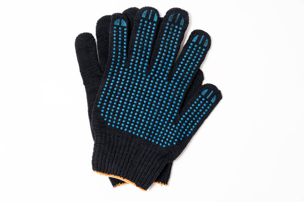 Closeup pair of black textile knitted gloves with professional b - Photo, Image