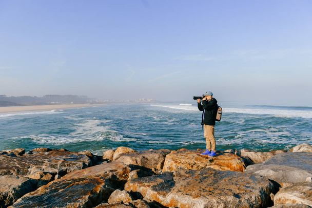 man taking photo of beautiful landscape from ocean cape in Portugal - Fotó, kép