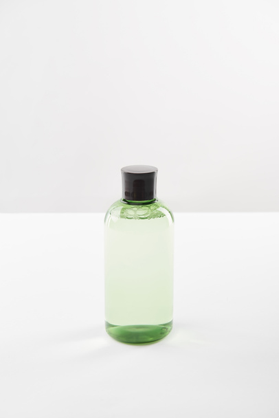 Cosmetic bottle with lotion on white background with copy space - 写真・画像