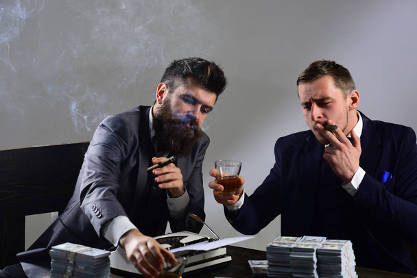 The work is done. Business partners with cash money. Successful investment in business. Businessmen write financial report while drinking and smoking. Money brokers counting profit increase - Valokuva, kuva
