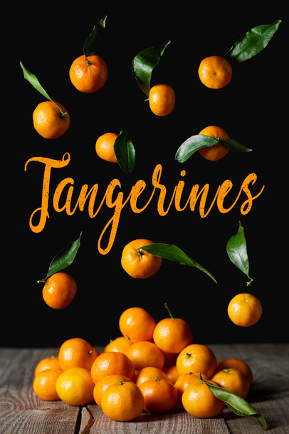 organic tangerines with green leaves isolated on black - Photo, Image