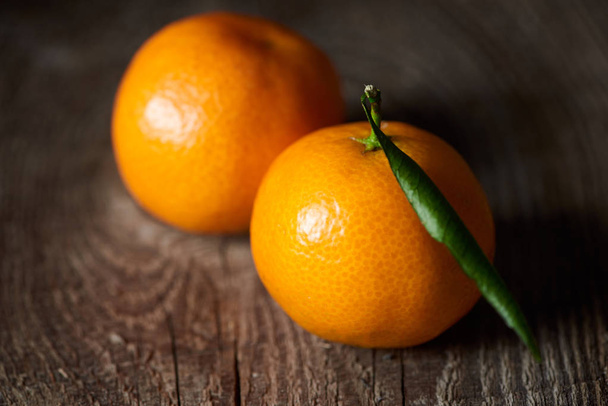 selective focus of juicy orange tangerines on wooden table  - Photo, Image