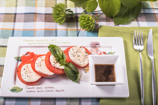 Snack with fresh tomatoes and cheese served on platter - Foto, Imagen