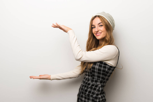 Fashionably woman wearing hat holding copyspace to insert an ad - Photo, Image
