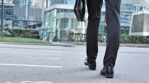 Walking Legs of Businessman, Holding Handbag in Hand - 写真・画像
