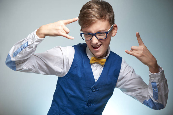 Boy teenager with braces in glasses. Wearing a shirt with a bow tie. On the teeth of dental braces. - Foto, Imagem