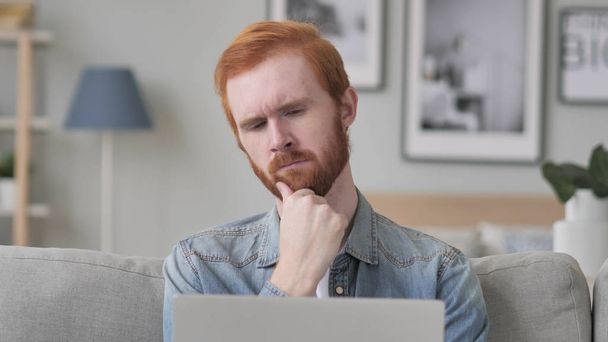 Pensive Beard Man Thinking while Using Laptop - Photo, Image