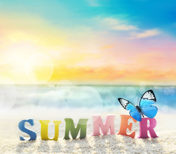 Summer beach. Word summer of color letters on summer beach and butterfly on a background of ocean. - Valokuva, kuva