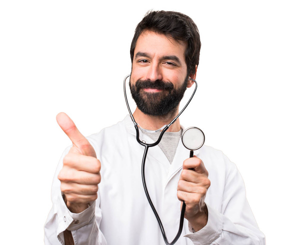 Young doctor with stethoscope on white background - Foto, imagen