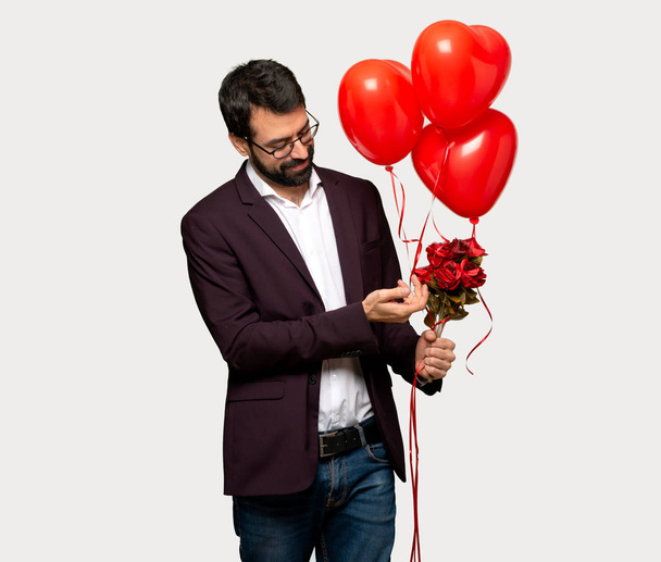 Man in valentine day smiling with a sweet expression over isolated grey background - Фото, зображення
