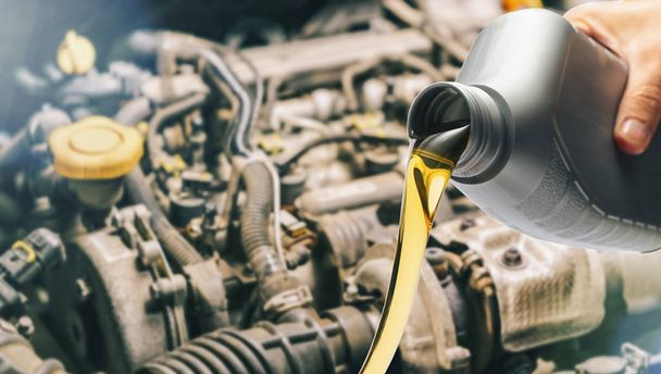 Pour motor oil into car engine. Maintenance service change liquids and fluid. - Photo, Image
