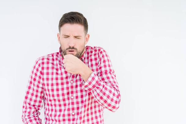 Young handsome man wearing shirt over isolated background feeling unwell and coughing as symptom for cold or bronchitis. Healthcare concept. - Photo, Image
