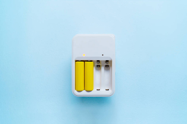 Picture of charger with yellow batteries - Photo, Image