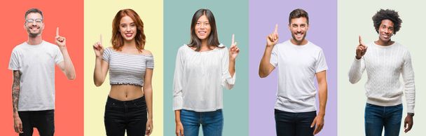 Composition of african american, hispanic and chinese group of people over vintage color background showing and pointing up with finger number one while smiling confident and happy. - Foto, Imagen