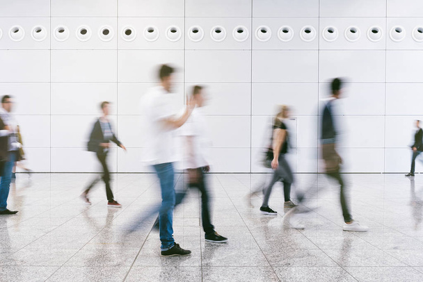 crowd of anonymous blurred people walking in a modern hall - Foto, immagini