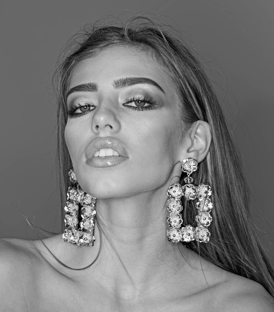 Glamour jewelry of luxury big earrings. Girl with sexy lips makeup. Fashion model with trendy look. Beauty on party. My favorite earrings. Sexy woman with fashionable makeup on face - Фото, изображение
