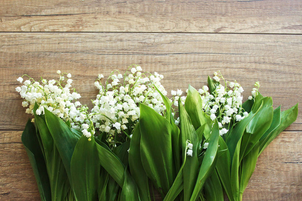 Spring bouquet of lilies of the valley, Lily of the valley on a wooden background. Spring. - Photo, Image