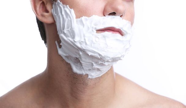 Young man shaving beard - 写真・画像