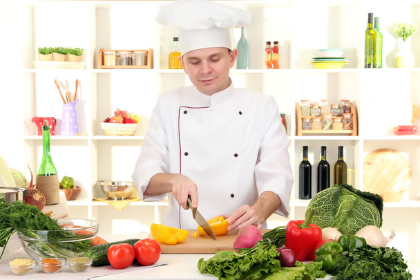 Chef cooking in kitchen - Фото, зображення