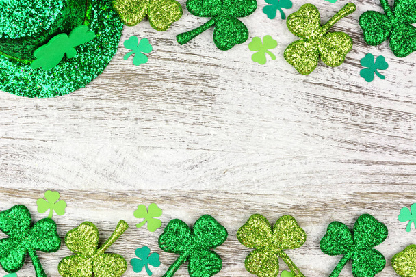 St Patricks Day double border of shamrocks with leprechaun hat over a rustic white wood background - Foto, imagen