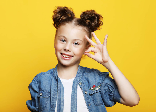 emotion, childhood and people concept:   little girl  showing ok gesture - Фото, зображення