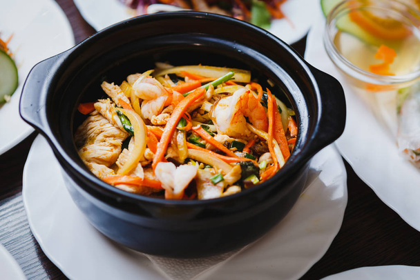 Delicious shrimps in sauce & vegetables.Exotic Vietnam food menu in restaurant.Asian seafood dish in Chinese restaurant.Close up,focus on shrimp - Foto, Imagen
