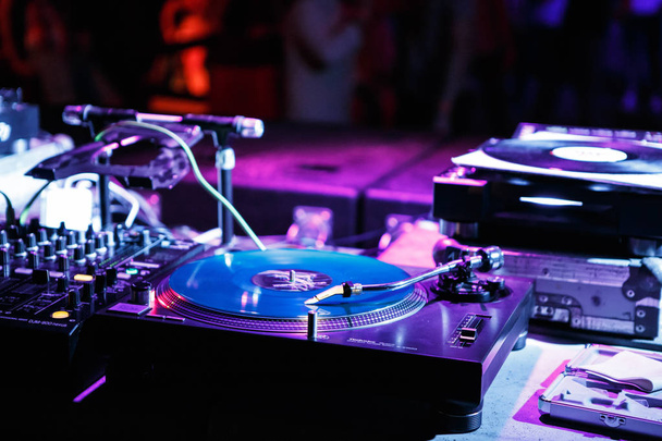 KIEV-4 JULY,2018: Retro dj Technics turntables with vinyl records on concert stage in music hall.Professional disc jockey audio equipment on electronic festival in nightclub - Foto, Imagen