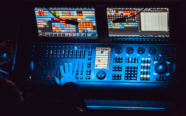 MOSCOW - 20 OCTOBER,2016: Professional concert sound and stage lighting technician at work.DMX scene light control panel.Faders and knobs to control color and volume - 写真・画像