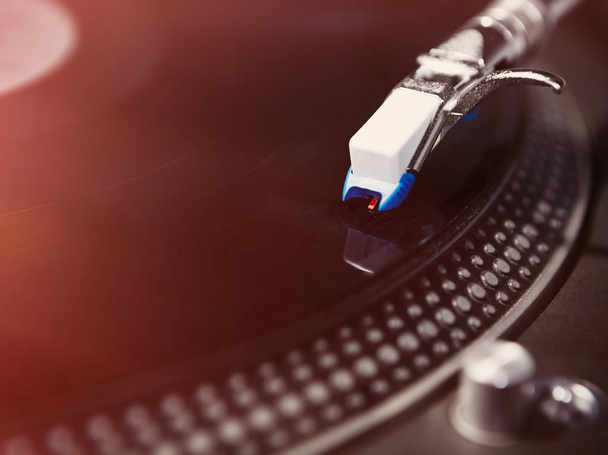 Close up on vinyl record player playing analog disc with music. Turntable for professional DJ.Disc jockey turntables needle in focus.Scratch records,play tracks - Foto, Imagem