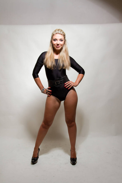 Attractive young female posing in the studio dressed in sexy body-suit  - Zdjęcie, obraz