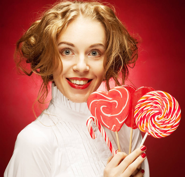 woman with heart caramel over red background  - Zdjęcie, obraz