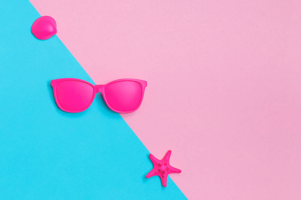 Pink glasses and seashells on colorful background. Minimal concept. Creative concept. Hot Summer Vibes. Pop Art. Bright Sweet fashion Style. - Photo, Image