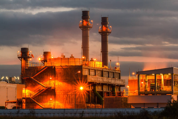 Petrochemical oil refinery plant with blue and Twilight image of a power plant in a beautiful evening - Photo, Image