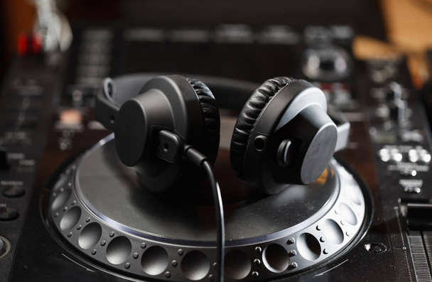 Headphones on CD music disc player for DJ. Top class audio equipment for studio,event,concert. Widely used by professional disc jockey. Macro, close up - Photo, image