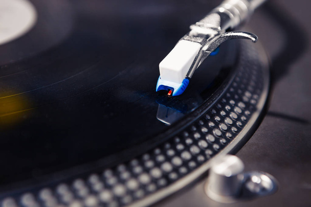 Close up on vinyl record player playing analog disc with music. Turntable for professional DJ.Disc jockey turntables needle in focus.Scratch records,play tracks - Photo, image