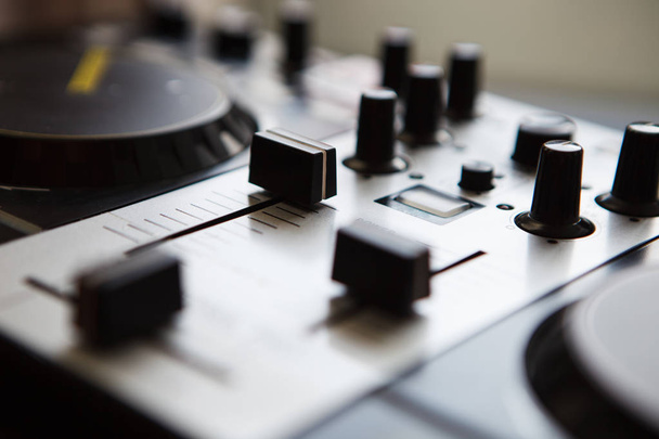 Professional audio mixer for DJ. Midi sound mixing controller close up. Focus on knobs. Play music loud  - Foto, Bild