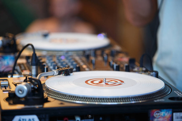 KIEV-11 JULY,2018: Professional dj turntables Technics SL 1210 and Pioneer sound mixer on stage at summer music festival Bazar. Pro disc jockey audio equipment on scene. Play and remix musical tracks - 写真・画像