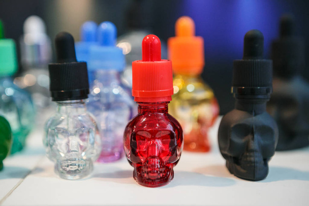 MOSCOW - 9 DECEMBER, 2016: International Vape Expo.Very popular modern electronic cigarette filling liquid.E-liquid, e-juice on sale in plastic bottle container. Eliquid, ejuice for vaping device gadget,fill vaporizer and vape safely. No nicotine - Foto, afbeelding