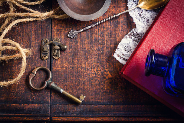 Vintage retro background with key and book - 写真・画像