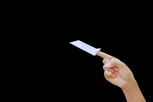 Close-up woman hand with white paper rocket on forefinger and pointing up isolated over black background.  Imagination concept. - Photo, image