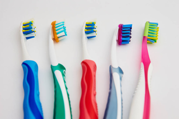 many toothbrushes on a white background - Zdjęcie, obraz