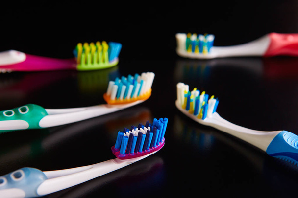 many toothbrushes on a white background - Foto, Imagem