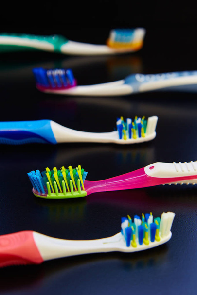 many toothbrushes on a white background - Fotó, kép