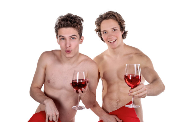 Two funny naked guys holding glasses with red wine and heart isolated on white - Foto, imagen